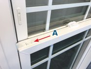 Latches (A) are located on the top corners of the bottom sash.