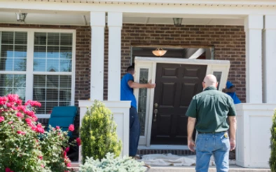 Champion installer carrying door into home