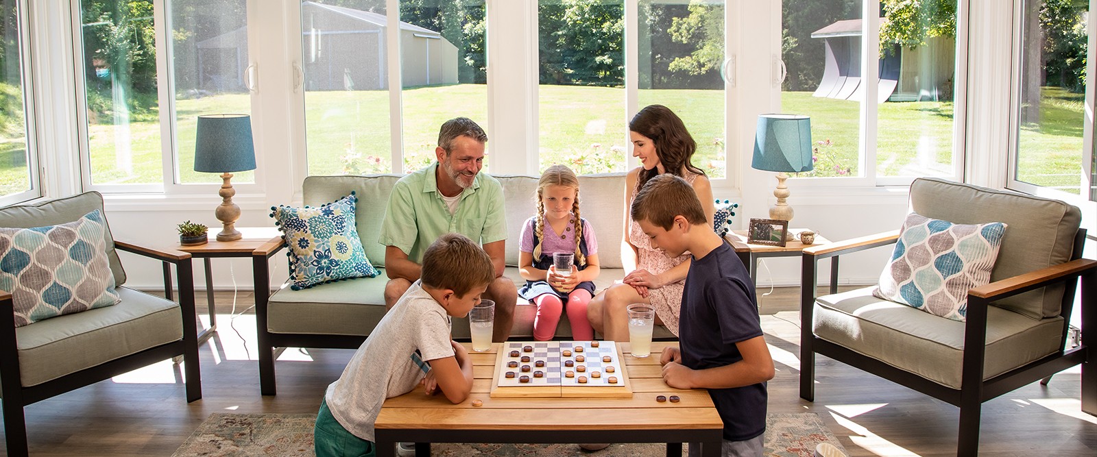 Family relaxing in Champion All-Season sunroom