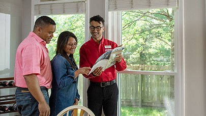Champion Sales Representative going over options with customers at an in-home visit