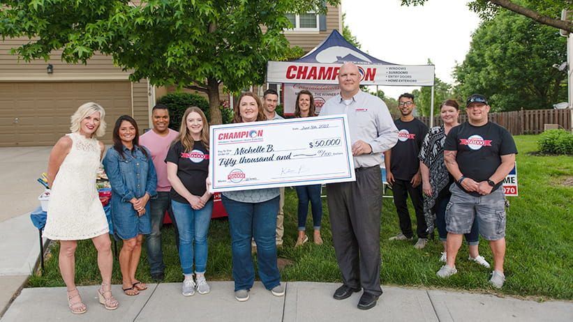 Champion contest winners with check