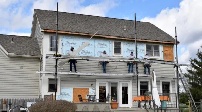 Champion installer working on new siding