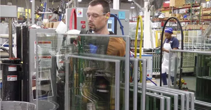 Champion factory employee working on window