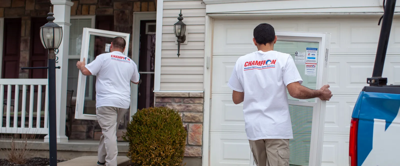 Champion installers carrying door to be installed