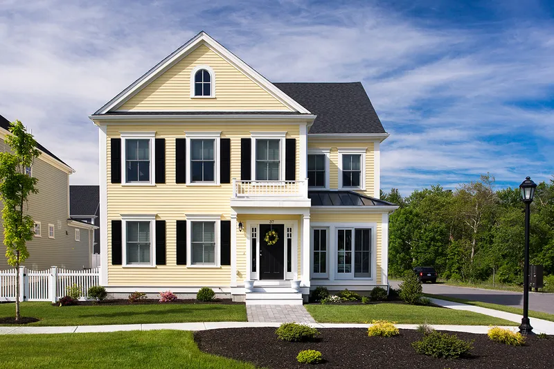 Yellow house with fiber cement siding.