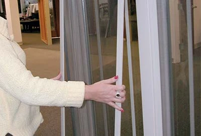 Person removing screen from Champion window