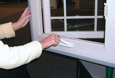 Person using crank to open window