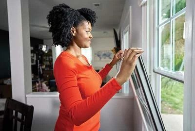 Person pulling top sash toward themself