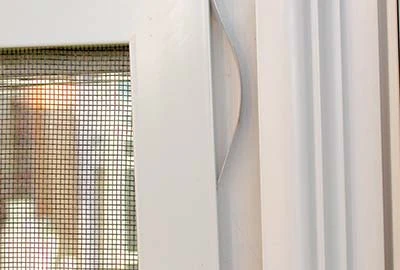 Photo of the top right window screen spring