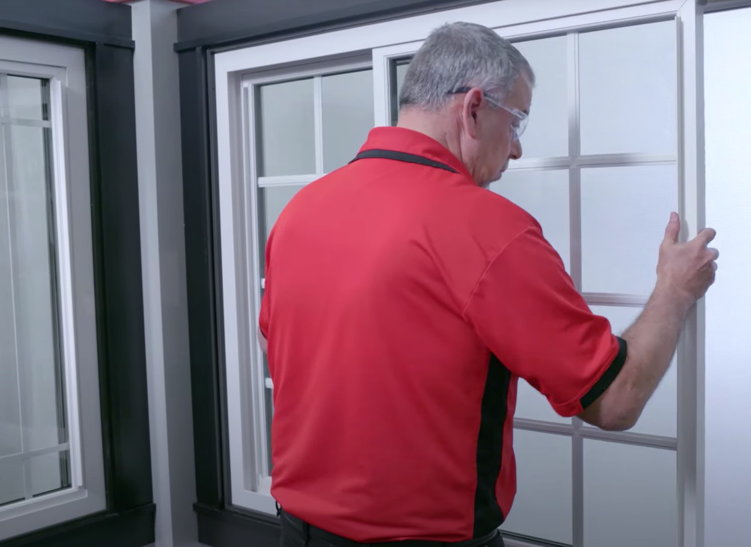 Champion employee removing screen from window