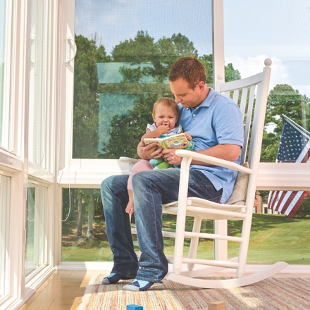 Woman reading a book in her Champion sunroom