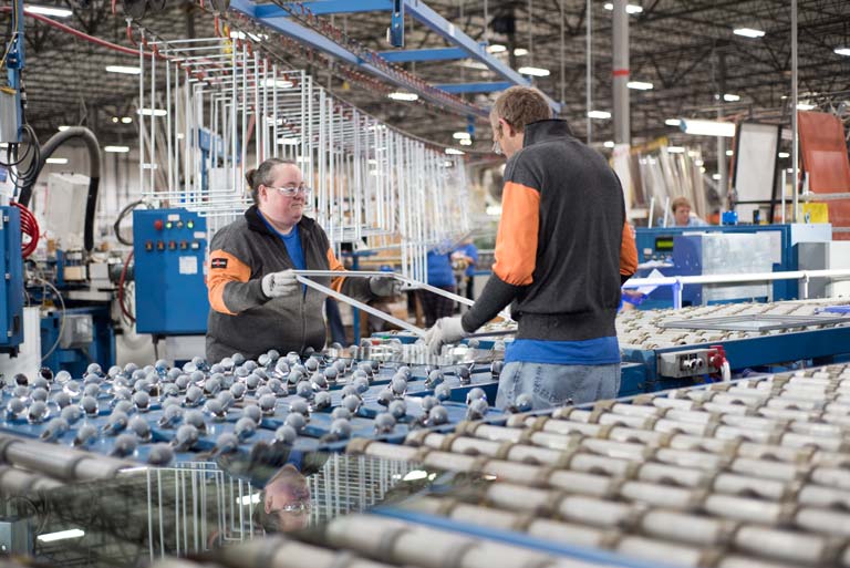 Champion employees working on assembling window frames