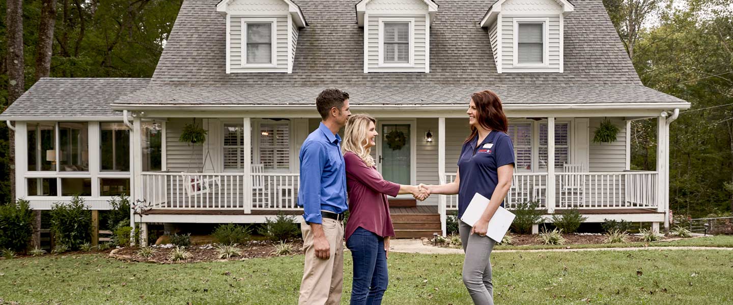 Champion Representative reviewing options with homeowners outside home